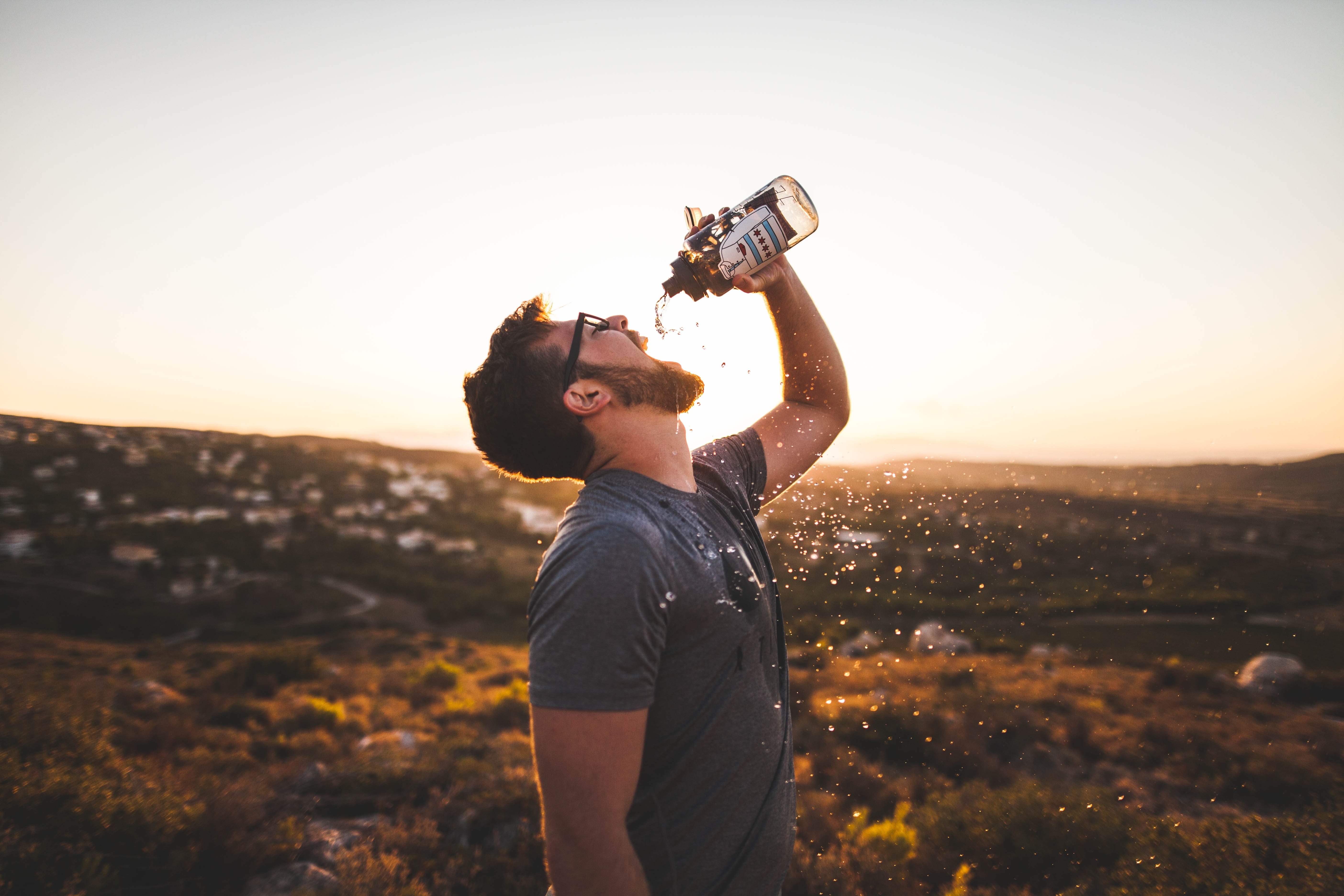 an image of a man drinking from a water bottle