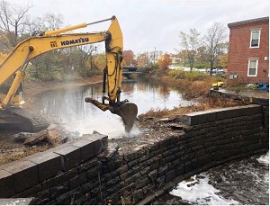 An image of heavy equipment removing a dam