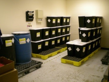 an image of drums of hazardous waste neatly lined up on pallets