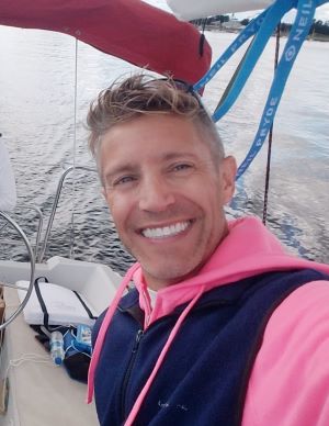Smiling man on sail boat.