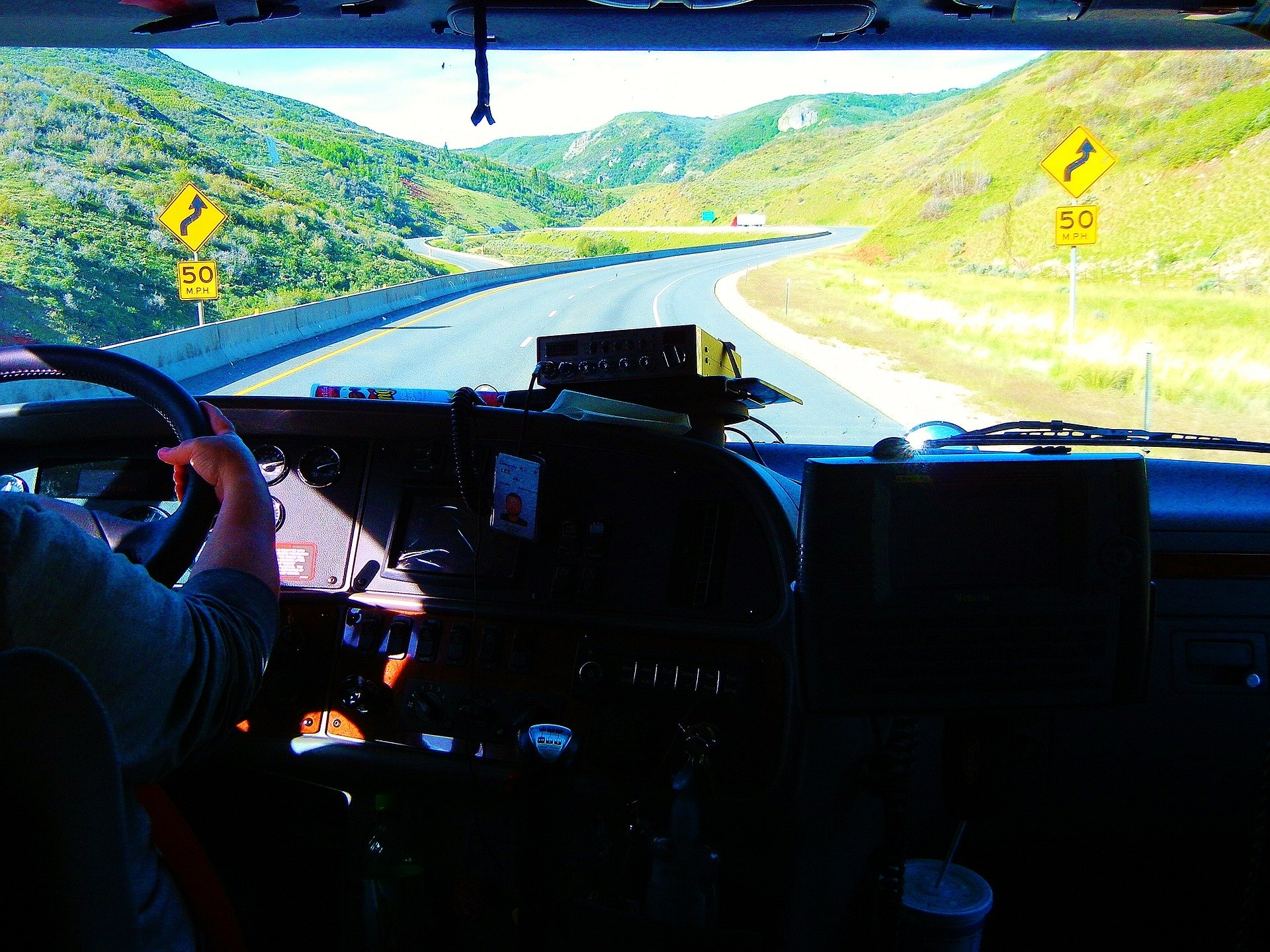 an image of a road taken from inside the cab of an 18-wheeler