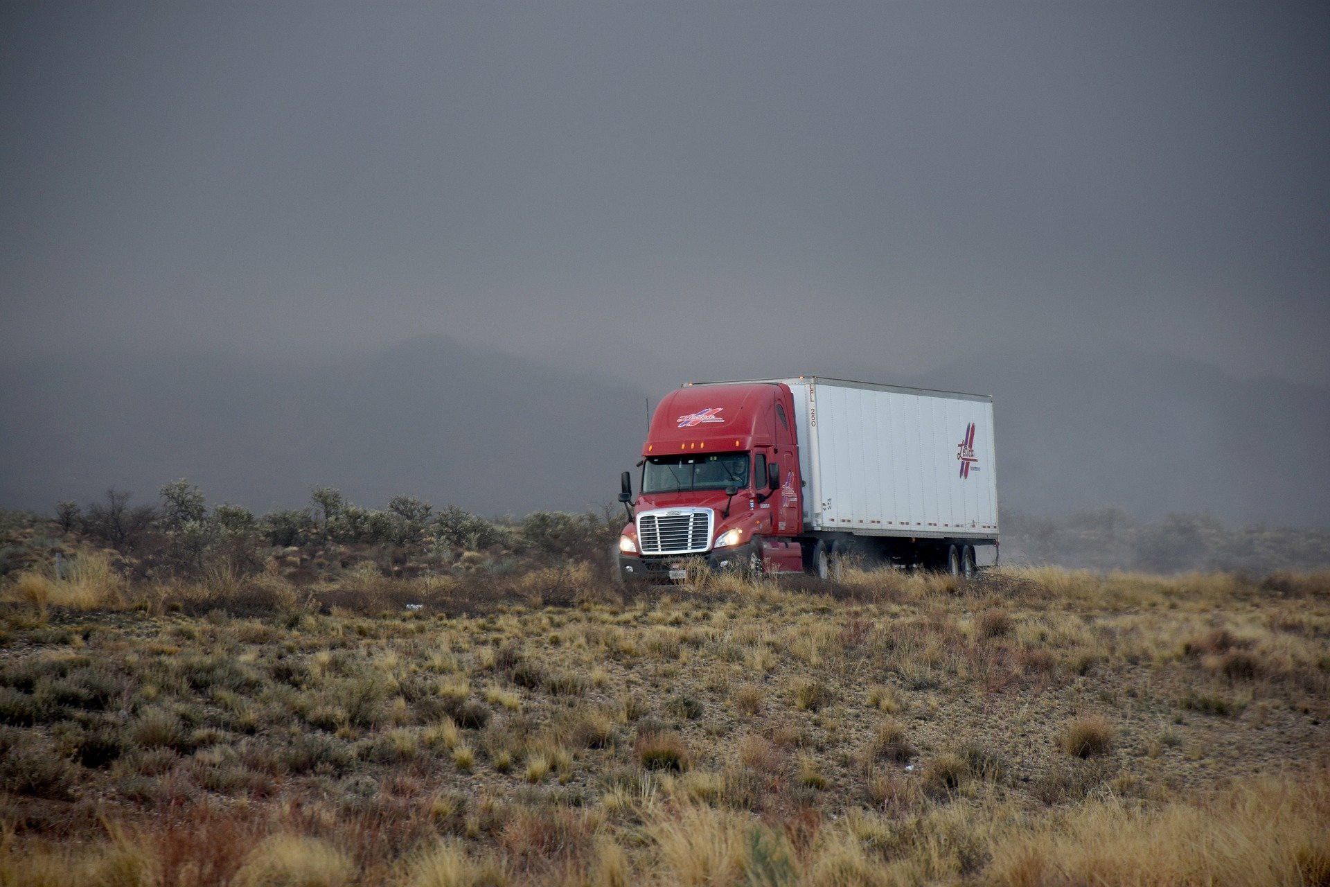 an image of an 18-wheeler truck on a highway