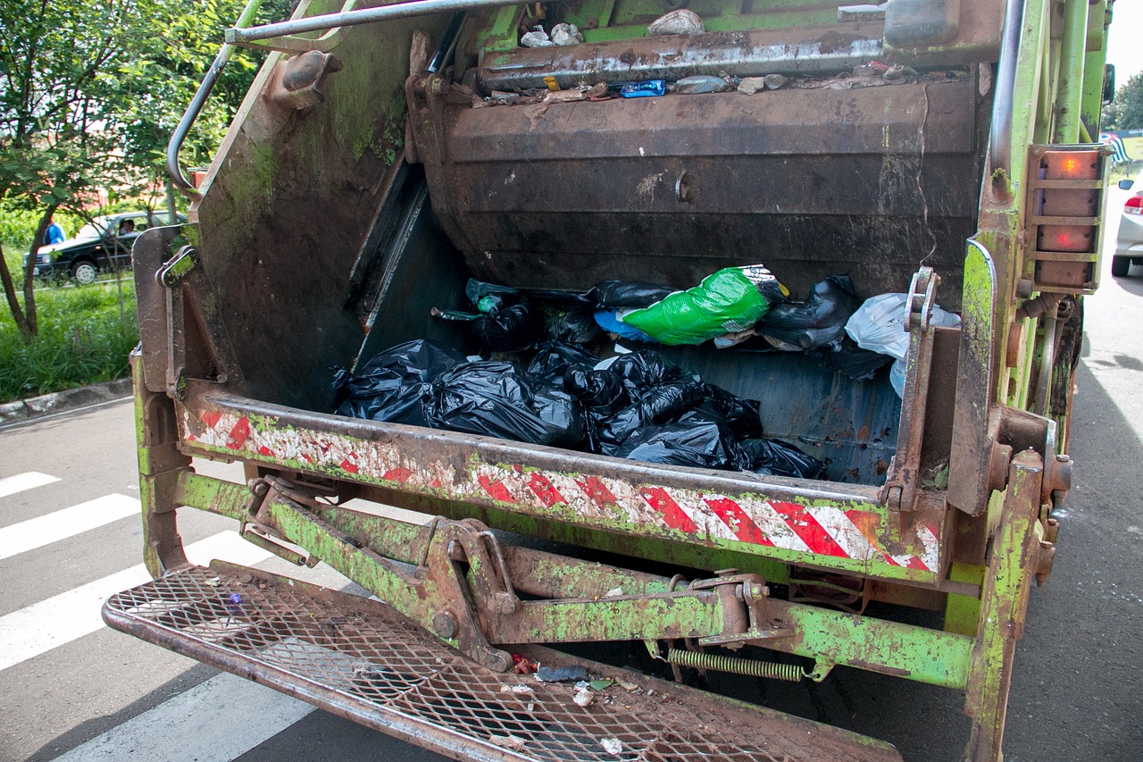 the back of a garbage truck with bags of MSW 