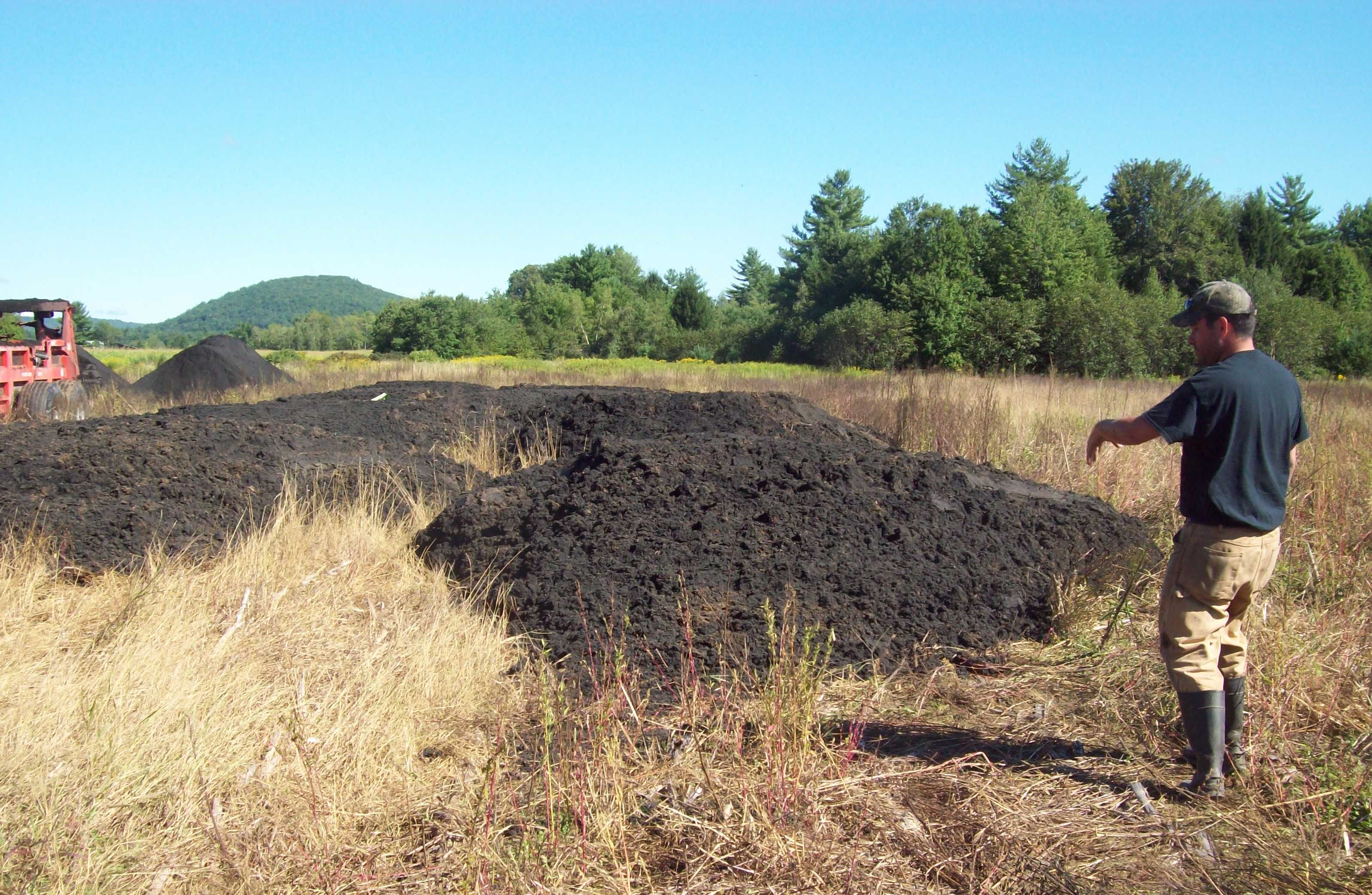 fall view of a field with biosoilds that have been dumped and are about to be spread at the direction of a consultant 