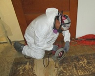 asbestos abatement worker in PPE 