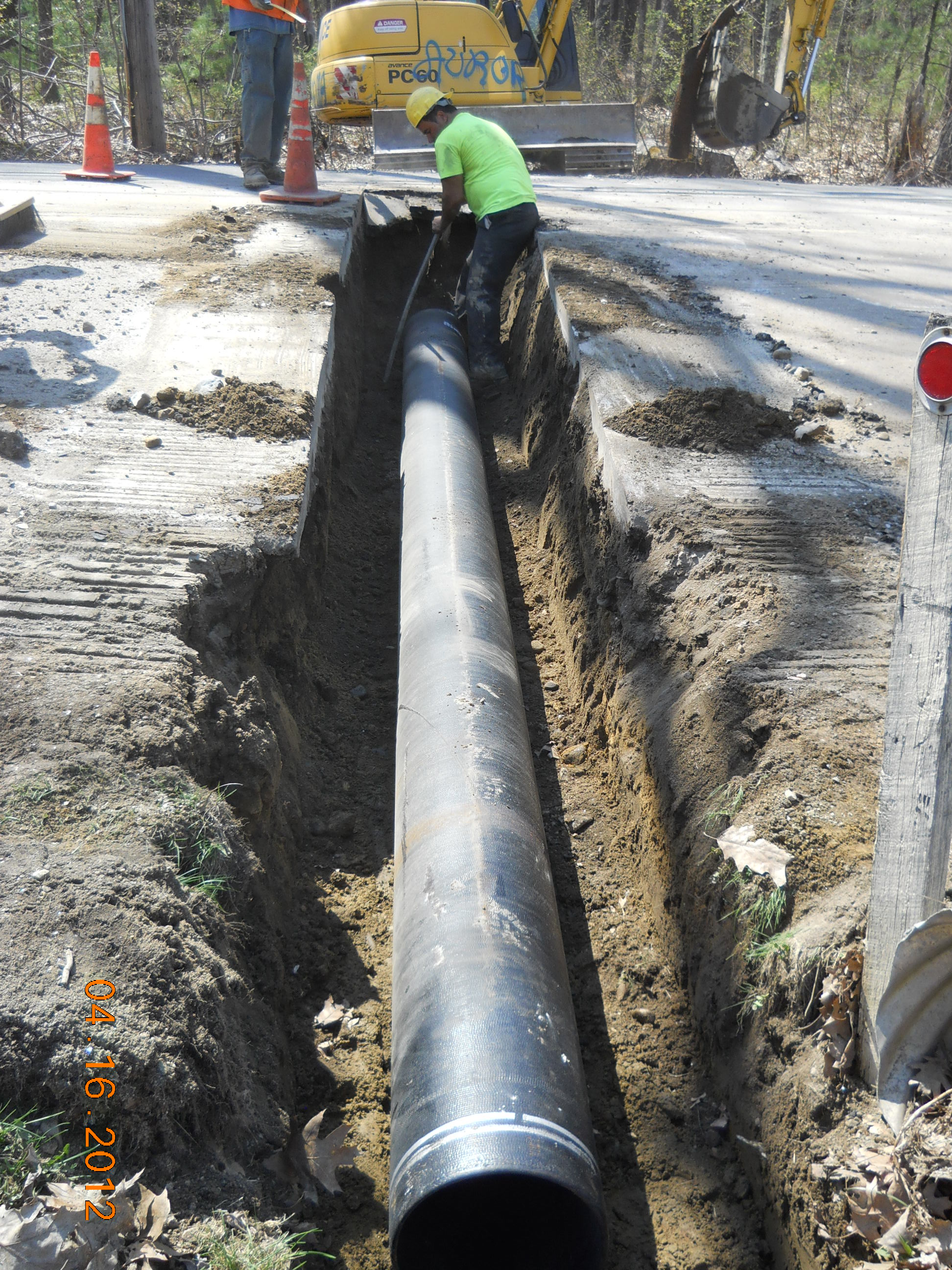 image of pipelayer installing water main
