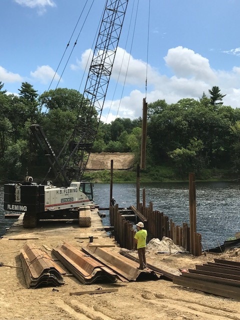 image of crane installing sheet piles during construction of dwsrf funded pennichuck water works Merrimack river crossing project
