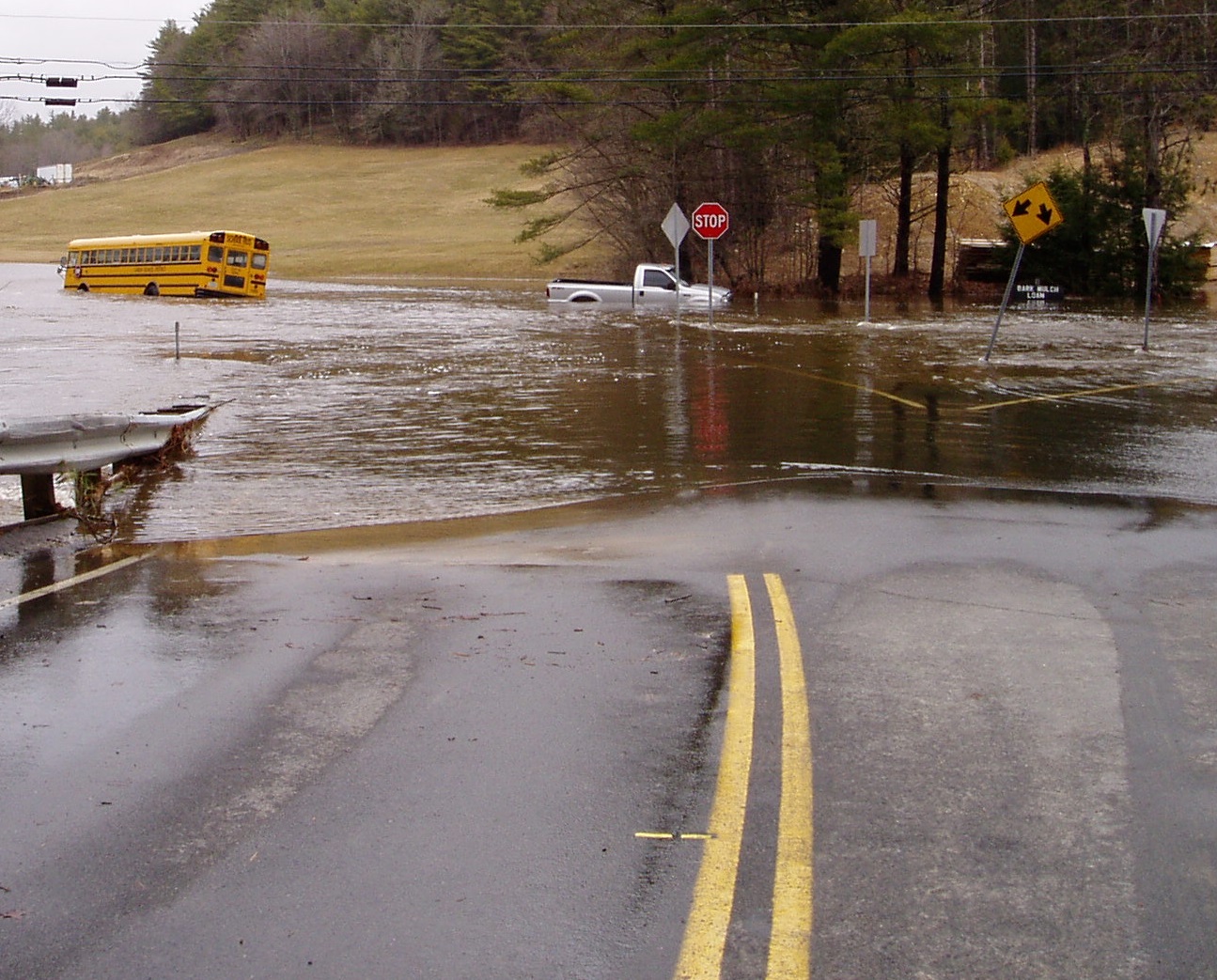 A bus is surrounded by flooding waters.