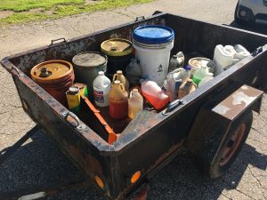 containers of household hazardous waste in an open trailer