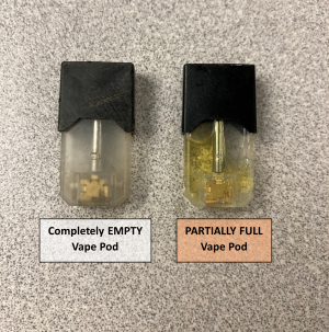 one empty vape pod and one partially full vape pod with nicotine e-liquid