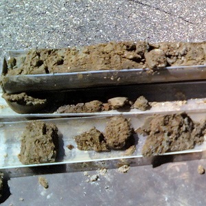 two core samplers filled with soil
