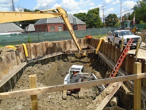 construction crew digs up soil