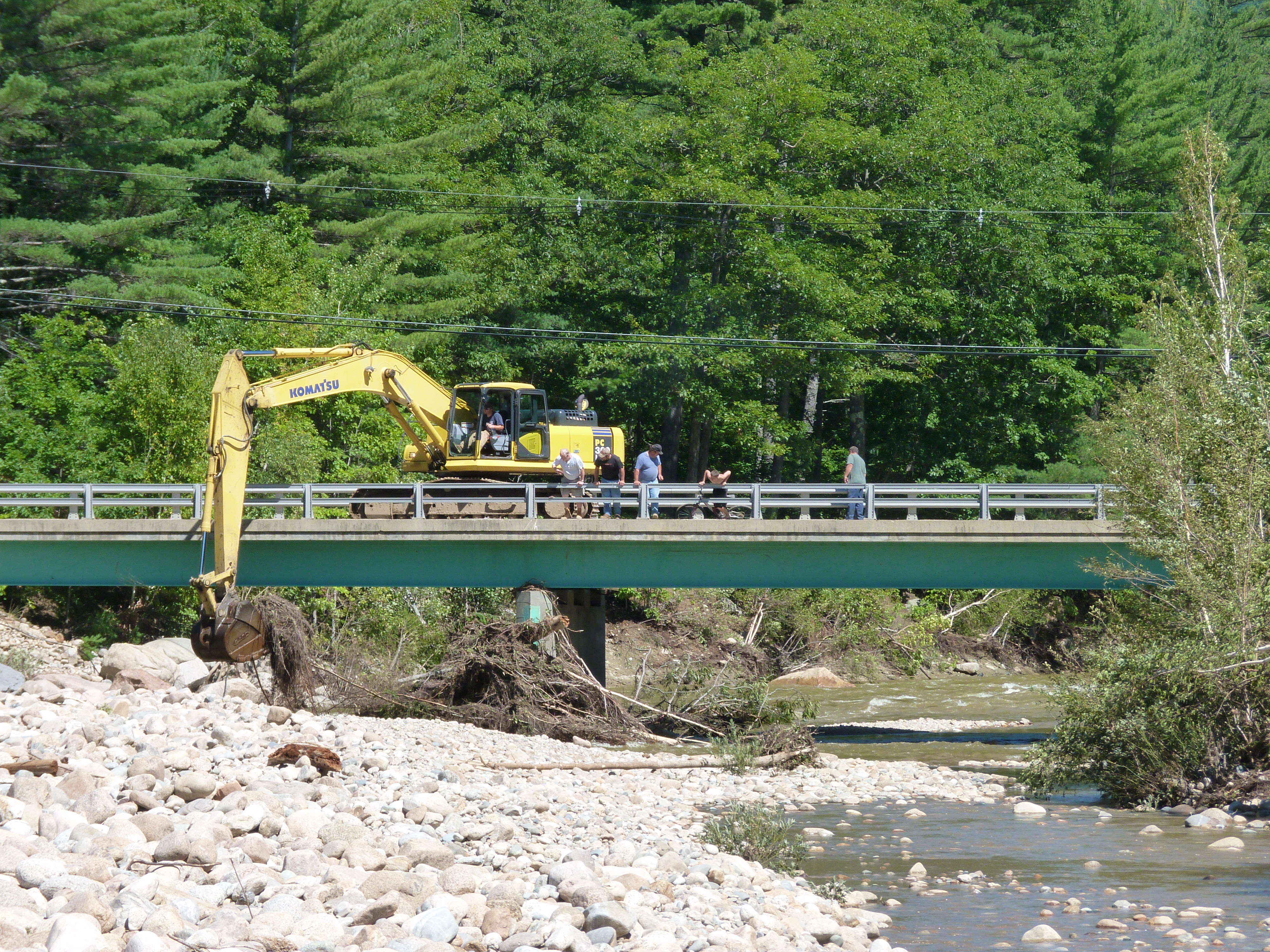 exacavator removing debris from a bridge after tropical storm irene