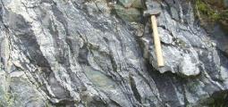 hammer rests on rock formation