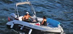 two people cruising in a motorboat