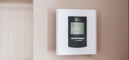 a digital thermostate on the wall