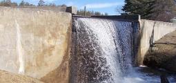 water splashes over a dam
