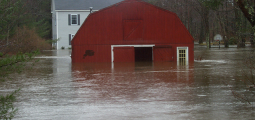 a barn and house under flood water