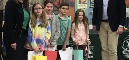 poetry contest winners pose with their prizes