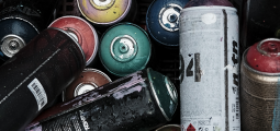 pile of spray paint canisters