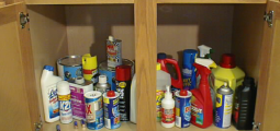 household cleaning items stored in a wooden cabinet
