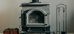 black household woodstove on a brick platform