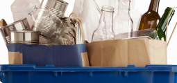 blue recycling bin filled with empty food and beverage containers