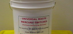 opaque white bucket labelled as universal waste for recycling