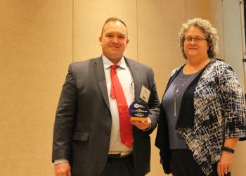 Photo of Collin Marchant receiving the 2023 Small Business Environmental Stewardship Award